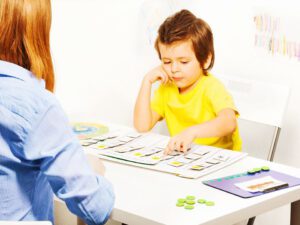 Child engaged in educational activity at a table